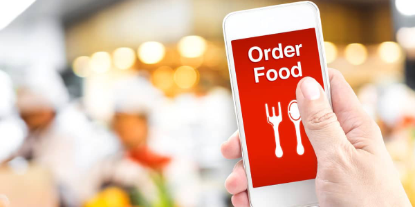 icon image for food ordering. image of a hand holding a phone that says order food. links to our 3rd party online ordering service for all 3 locations.